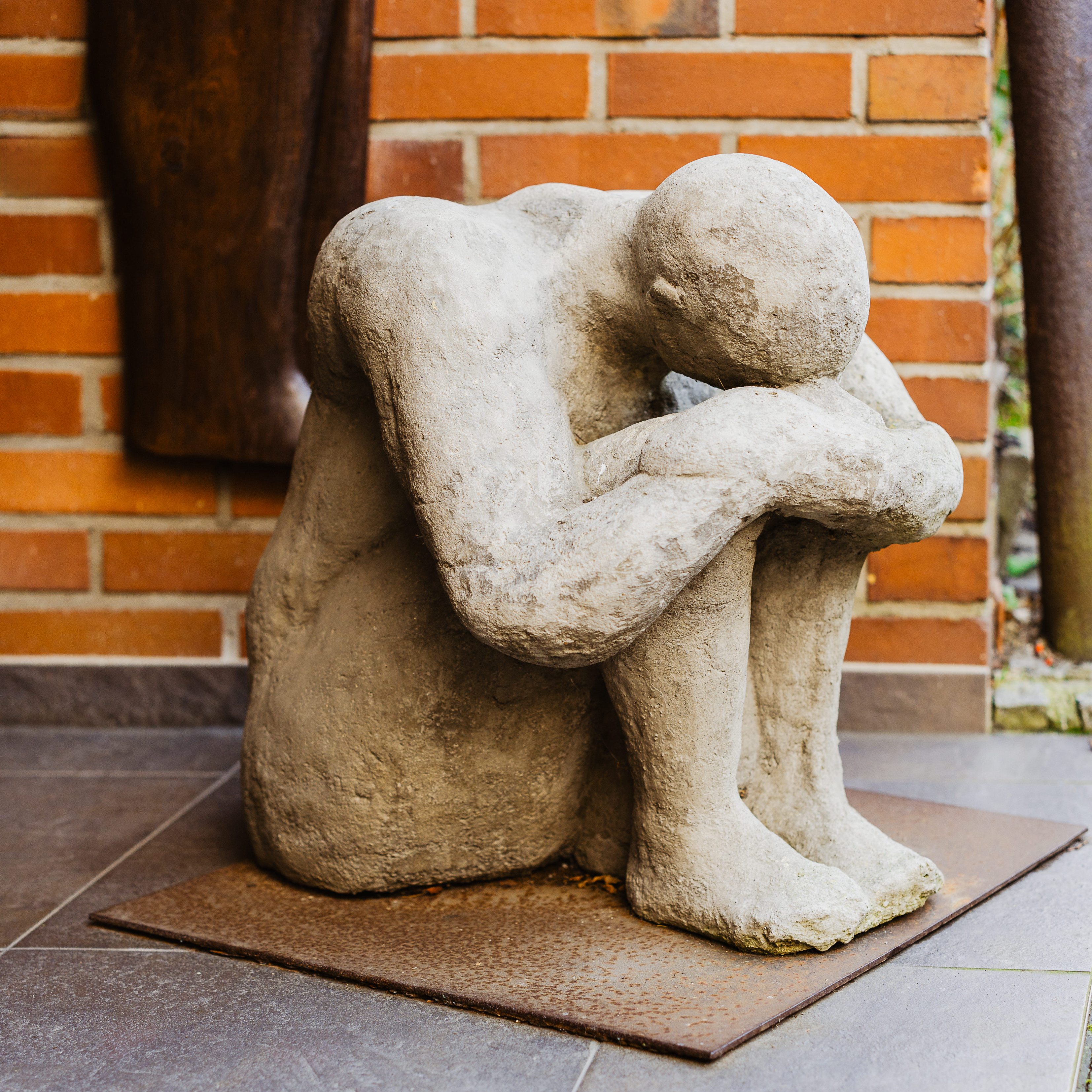 Nachdenkliche Skulptur symbolisiert Einsamkeit, Reflexion oder emotionale Belastung.